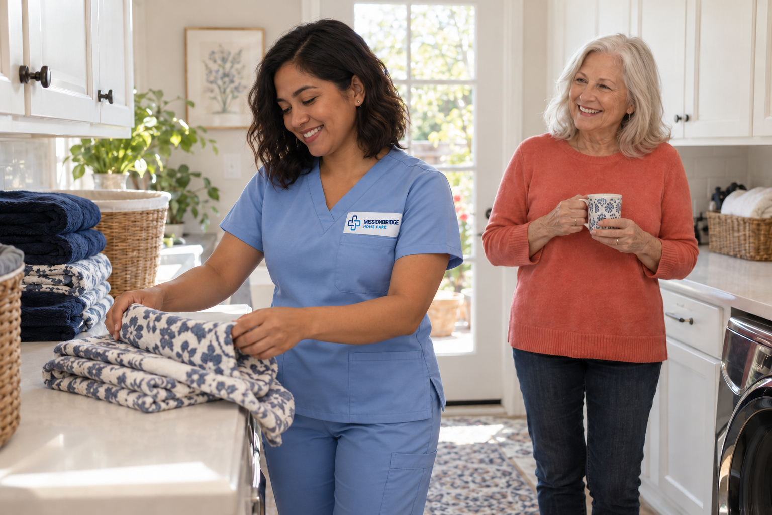 Illustrative Latina helper in branded light-blue scrubs folding towels with an older woman nearby